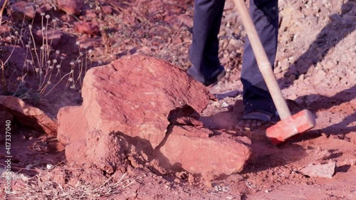 hammer smash with big stones mass break construction concept,steel hammer for destroy construct in construction area,laborer day,