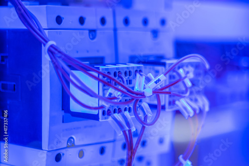 Tableau sur toile Contactor - electromechanical relay for switching electrical power circuit with blue illumination - close up