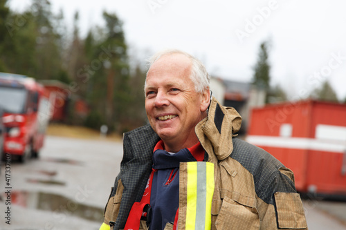 Smiling firefighter looking away photo