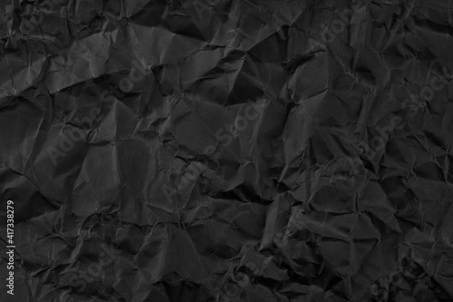 Black crumpled paper texture background.