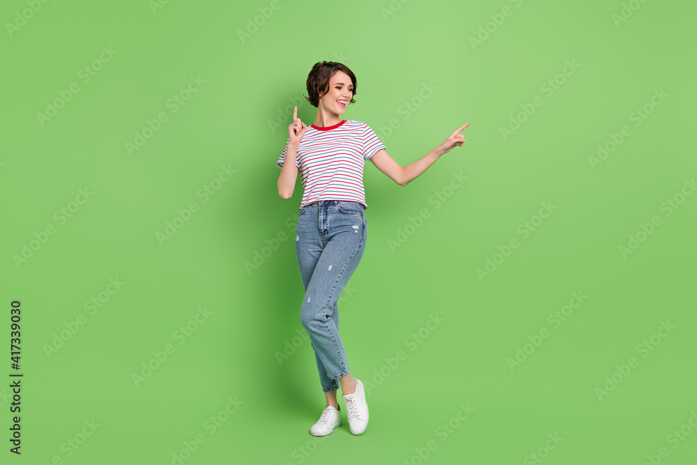 Full length body size view of attractive cheerful girl dancing having fun isolated over green pastel color background Full length body size view of attractive cheerful girl dancing having fun isolated over green pastel color background