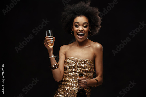 Photography Happy african american woman in party dress drinking champagne
