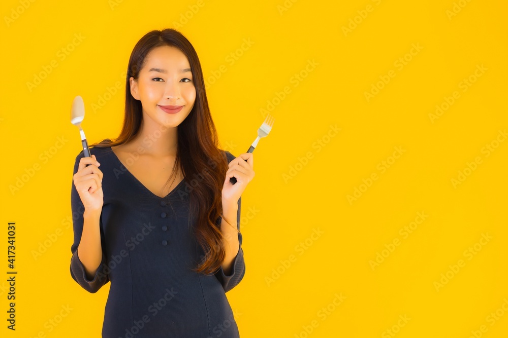 Portrait beautiful young asian woman with spoon and fork Portrait beautiful young asian woman with spoon and fork