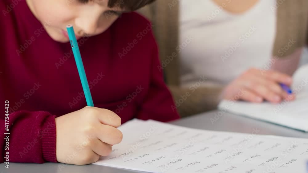 Close up of concentrated boy during doing math equation. Shot with RED helium camera in 8K. Close up of concentrated boy during doing math equation. Shot with RED helium camera in 8K.