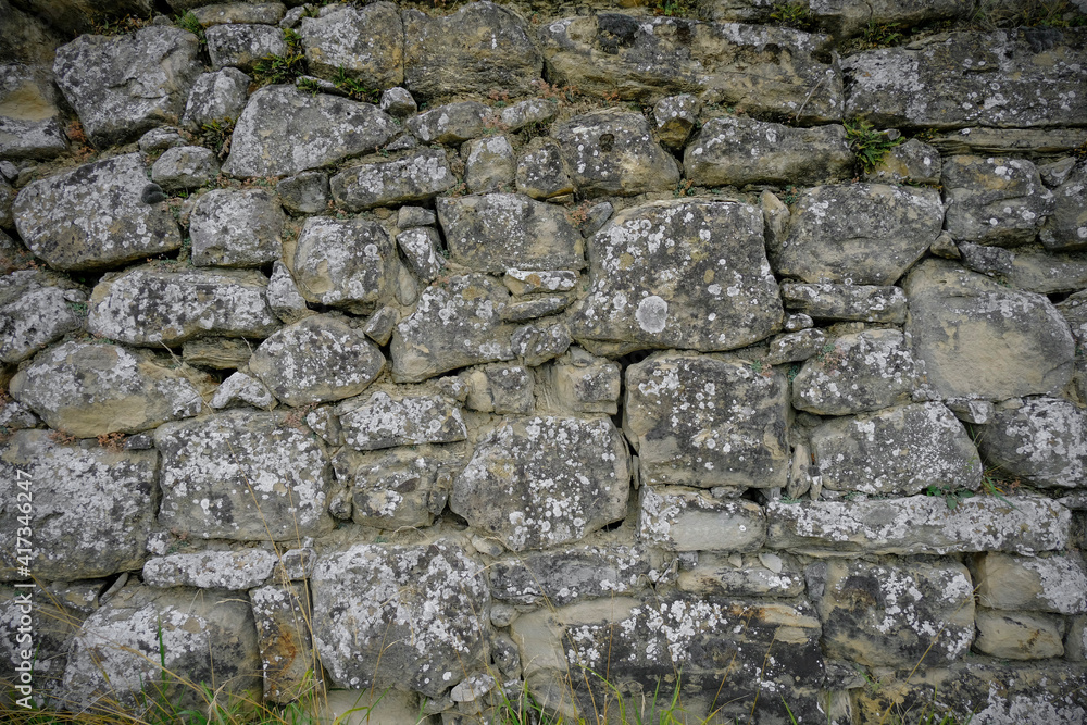 Grey textured stone wall background close-up. Copy space. Grey textured stone wall background close-up. Copy space.