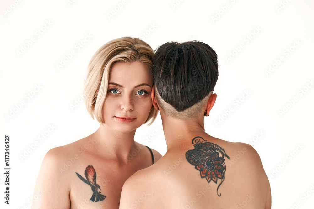 Foto de Sensual couple with love emotion, two beautiful sexy lesbian short  hair women touching on a naked body, present sex love sensuality heart  lgbt. do Stock | Adobe Stock