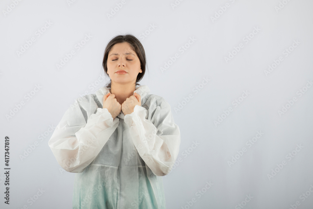 Portrait of young female doctor scientist in defensive lab coat posing Portrait of young female doctor scientist in defensive lab coat posing