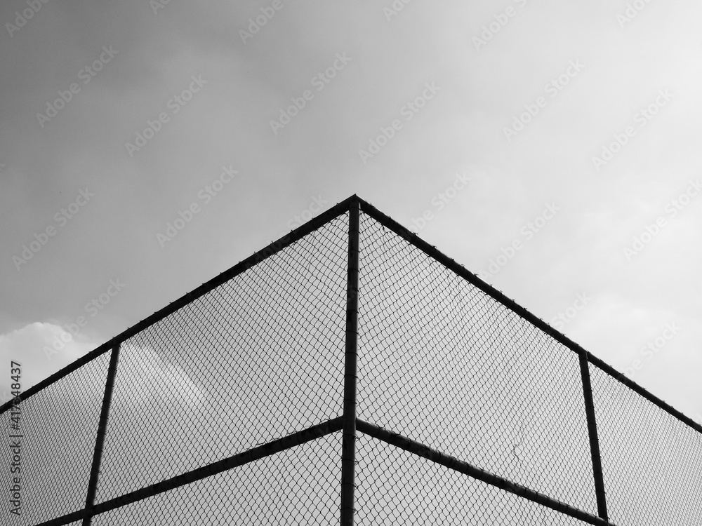 wire mesh of fence with sky background, black and white style