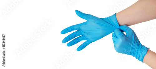 Doctor putting on protective gloves, isolated on white