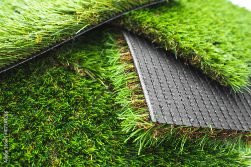 Detail of types of artificial grass in a sample book.