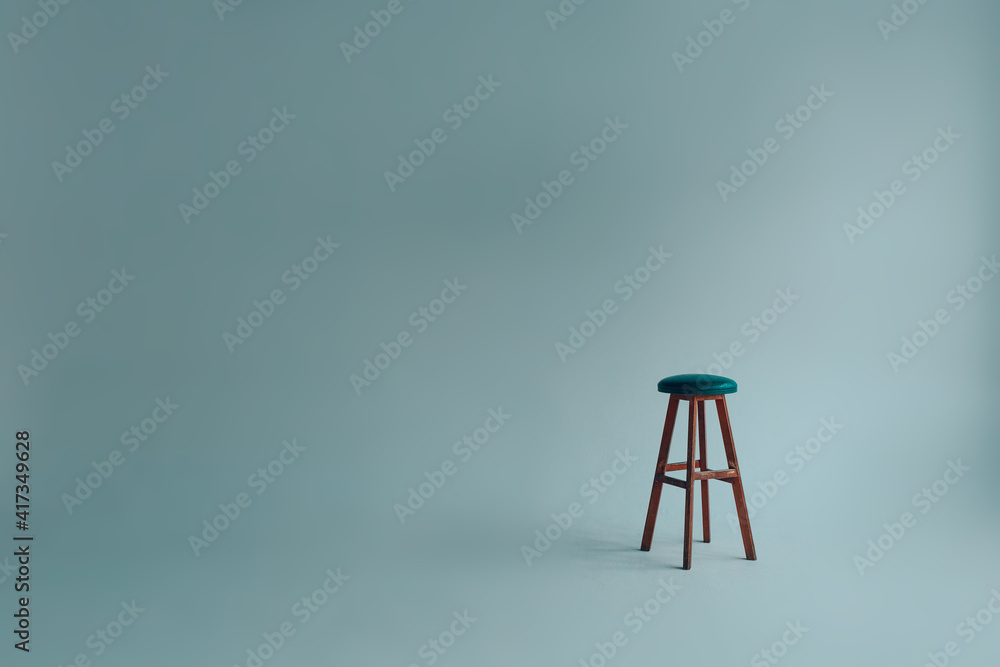 Bar stool with upholstered backless seat in an empty white room on a gray background Bar stool with upholstered backless seat in an empty white room on a gray background