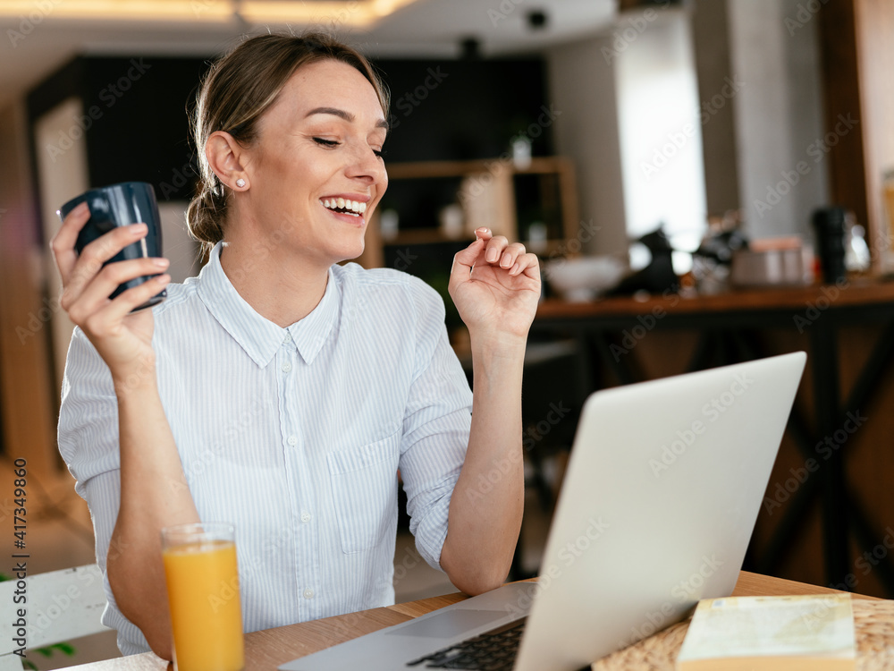 Beautiful woman drinking coffee and having video call. Young girl enjoying in morning coffee Beautiful woman drinking coffee and having video call. Young girl enjoying in morning coffee