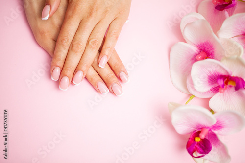 Woman applying hand cream at home, closeup