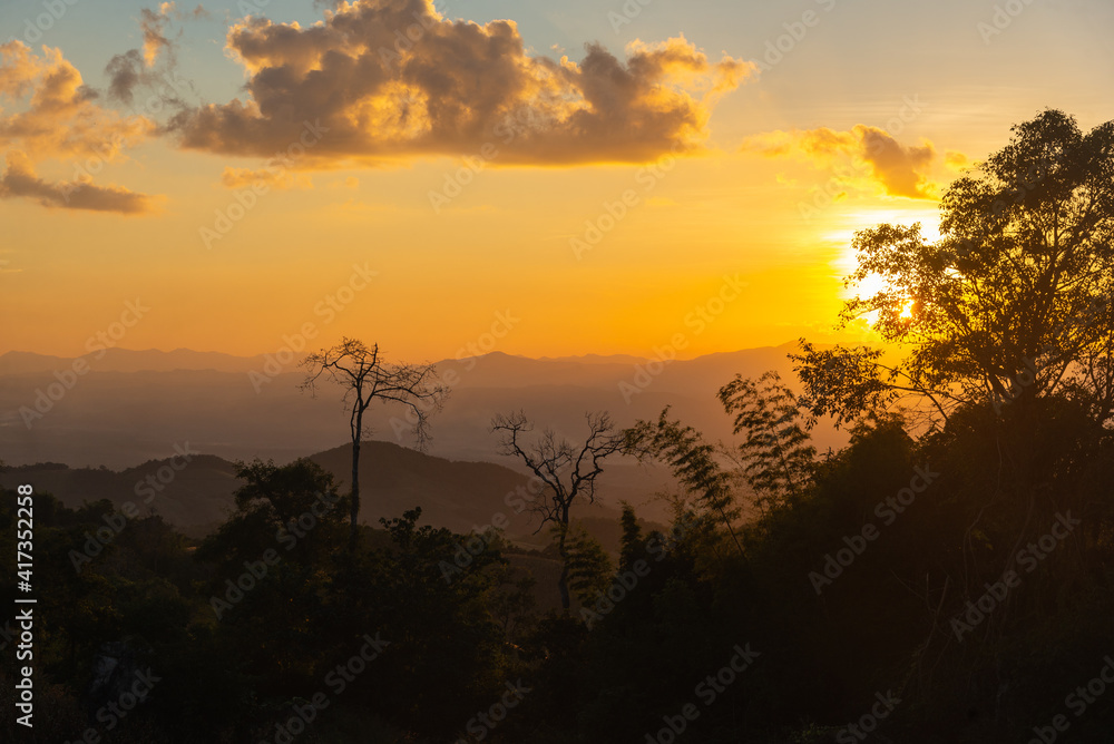 A beautiful evening sunset over the mountains In Nan Province, Thailand.