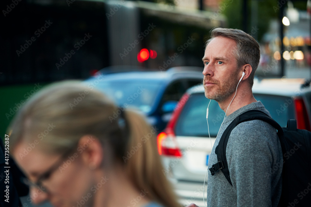 Man with earphones looking away Man with earphones looking away