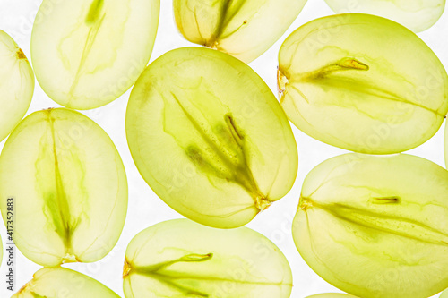 Halves of green grapes on white background, pattern.