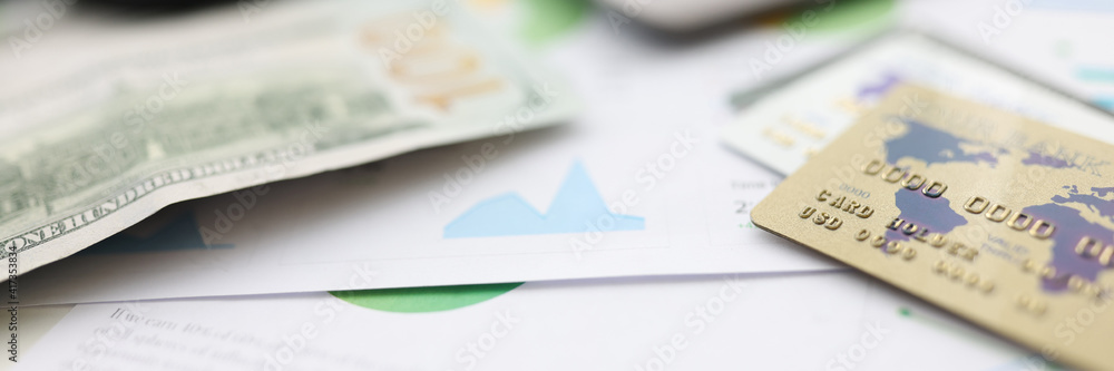 On table american dollars plastic cards and calculator and magnifying glass. Financial Empowerment Concept On table american dollars plastic cards and calculator and magnifying glass. Financial Empowerment Concept