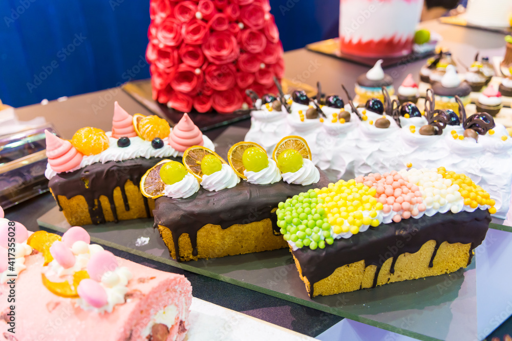 Fototapeta premium Catering sweets, closeup of various kinds of different types of Sweet Cakes in Bakery Shop