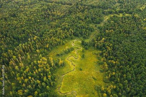 Aerial landscape of winding river in green field, top view of beautiful nature background from drone.