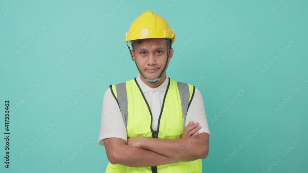 Portrait of male engineer crossing arms, smiling with confident face. Portrait of male engineer crossing arms, smiling with confident face.