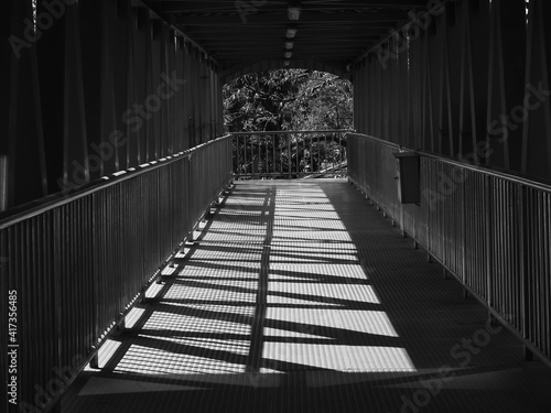 Fototapeta Naklejka Na Ścianę i Meble -  walkway on the overpass with sunshine and shadow, black and white style