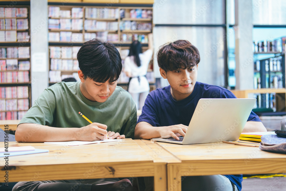 Young students campus helps friend catching up and learning. Young students campus helps friend catching up and learning.