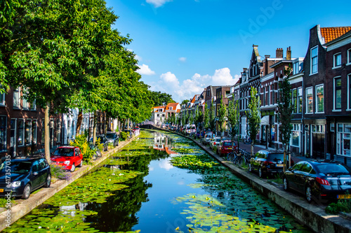 Delft, Netherlands - July 11, 2019: View of canals and brick houses of the town of Delft in the Netherlands