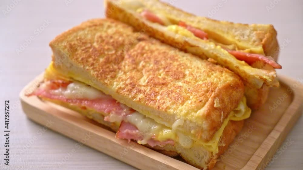 Homemade French toast ham bacon cheese sandwich with egg Homemade French toast ham bacon cheese sandwich with egg