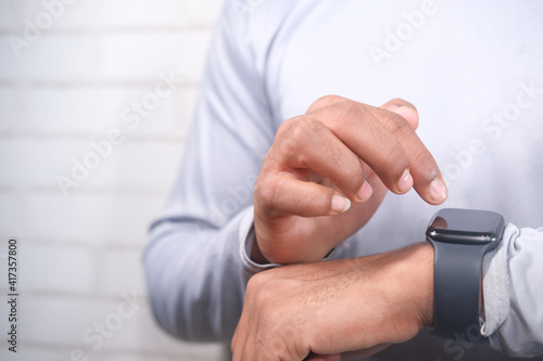  man's hand using smart watch.