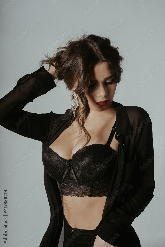A beautiful photo of a girl in the studio in a dressing gown, pants and a top. Gorgeous girl with big breasts. Fashionable photo of a brunette with red lips. A beautiful photo of a girl in the studio in a dressing gown, pants and a top. Gorgeous girl with big breasts. Fashionable photo of a brunette with red lips.