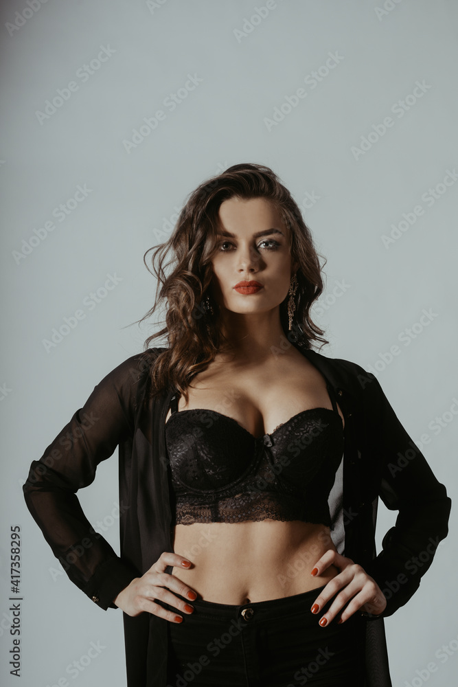 A beautiful photo of a girl in the studio in a dressing gown, pants and a top. Gorgeous girl with big breasts. Fashionable photo of a brunette with red lips. A beautiful photo of a girl in the studio in a dressing gown, pants and a top. Gorgeous girl with big breasts. Fashionable photo of a brunette with red lips.