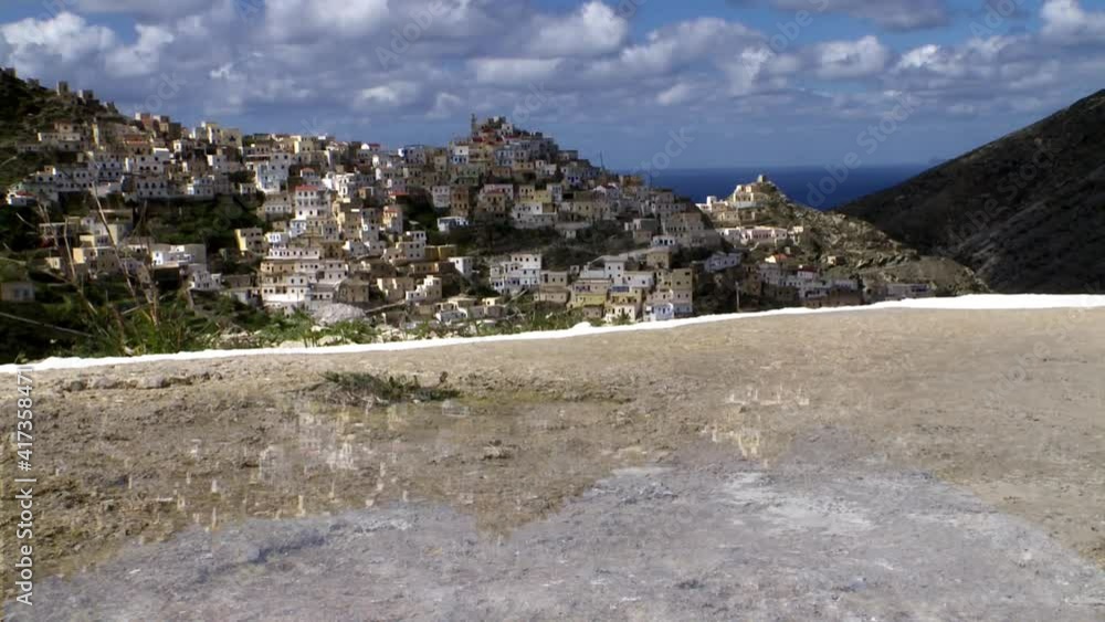 Karpathos Greece the village of Olympos built on the mountains and very often in the clouds with the very special architecture of his houses as if hanging from cliffs Time Lapse and reflection Karpathos Greece the village of Olympos built on the mountains and very often in the clouds with the very special architecture of his houses as if hanging from cliffs Time Lapse and reflection