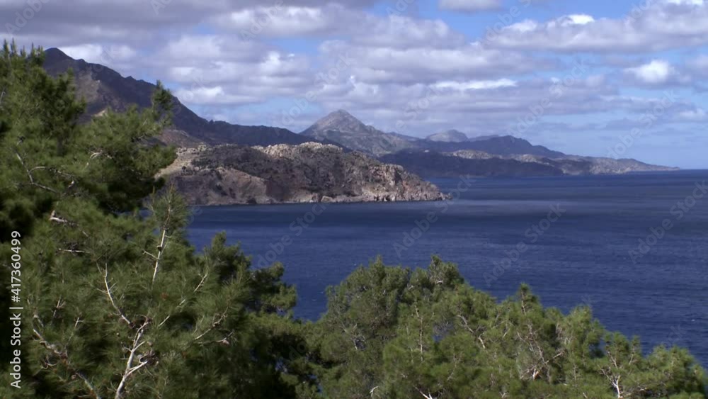 Karpathos Greece a classic landscape of the island sea mountains islands and clouds Pine trees Karpathos Greece a classic landscape of the island sea mountains islands and clouds Pine trees