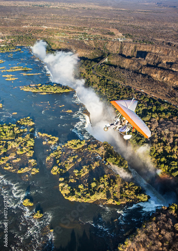 Tourists fly over the Victoria Falls on the trikes. Africa. Zambia. Victoria Falls.