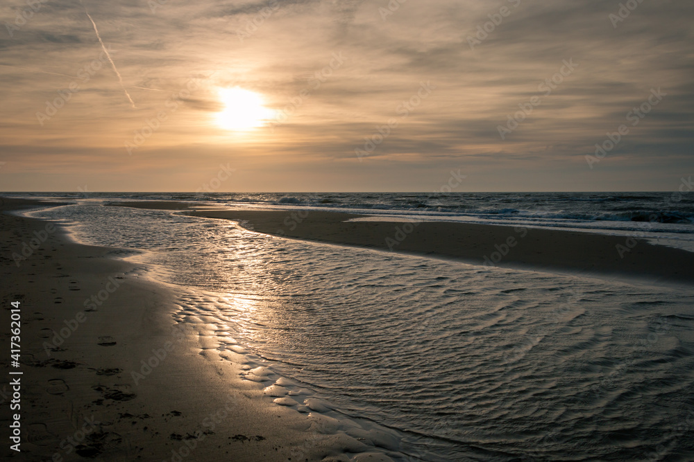 Sunset on a sunny winter day on the North Sea coast on the Wadden Island of Texel, the Netherlands