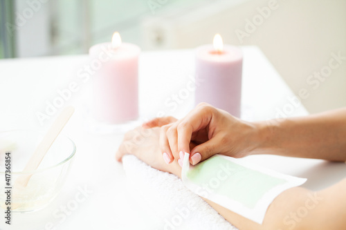 Canvastavla Woman doing hair removal on their hands at home in the bathroom