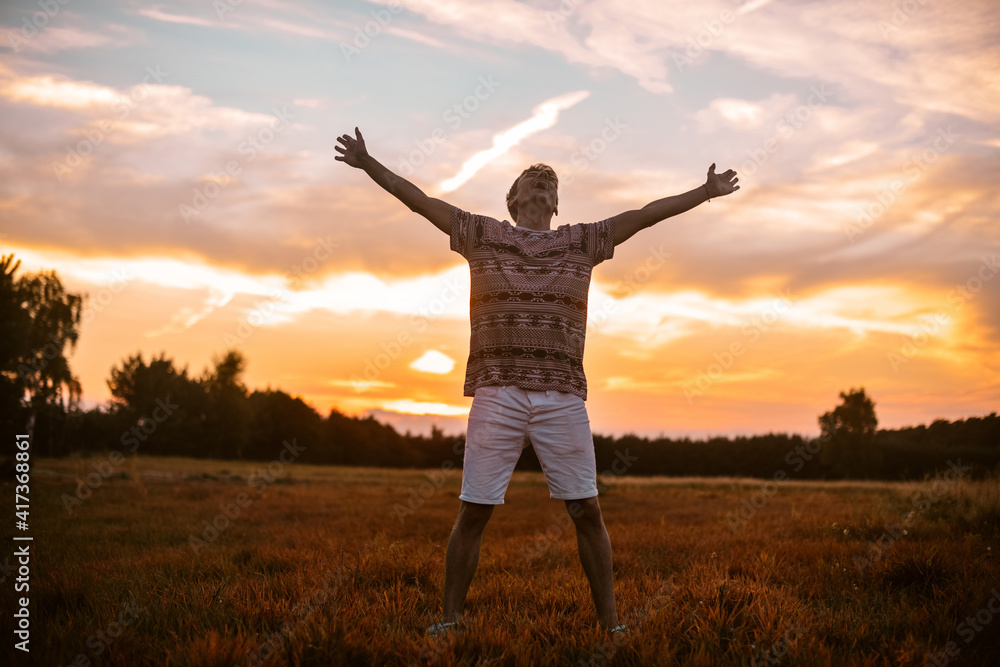 A man in the forest runs on the field, a happy man rejoices in freedom and tranquility. The guy in the field. A man in the forest runs on the field, a happy man rejoices in freedom and tranquility. The guy in the field.
