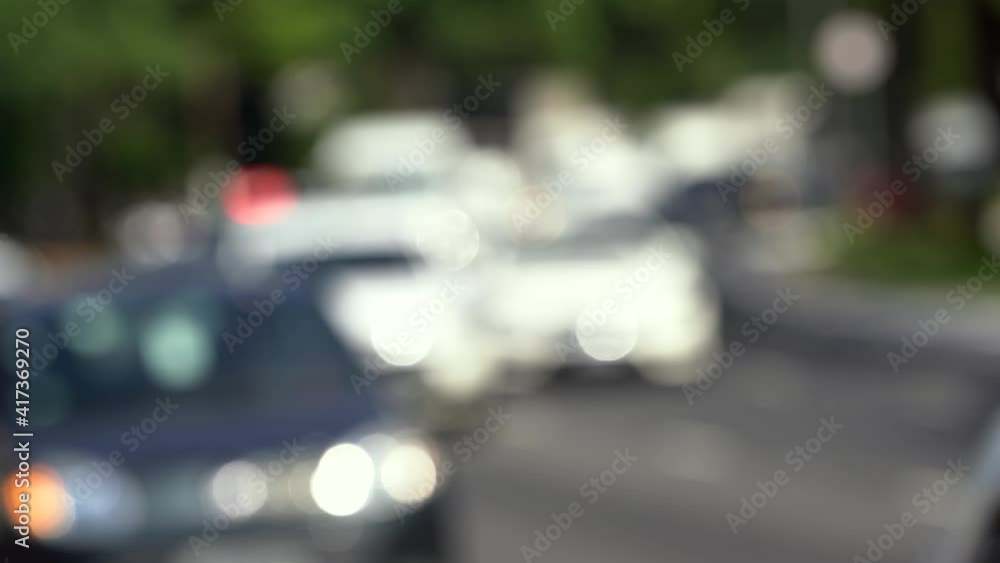 Traffic with blurred cars and the red lights of police in the background. Traffic with blurred cars and the red lights of police in the background.