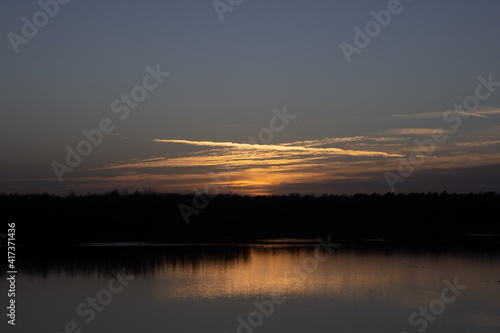 Dramatic and colorful sunset over a forest lake reflected in the water. Blakheide, Beerse, Belgium. High quality photo photo