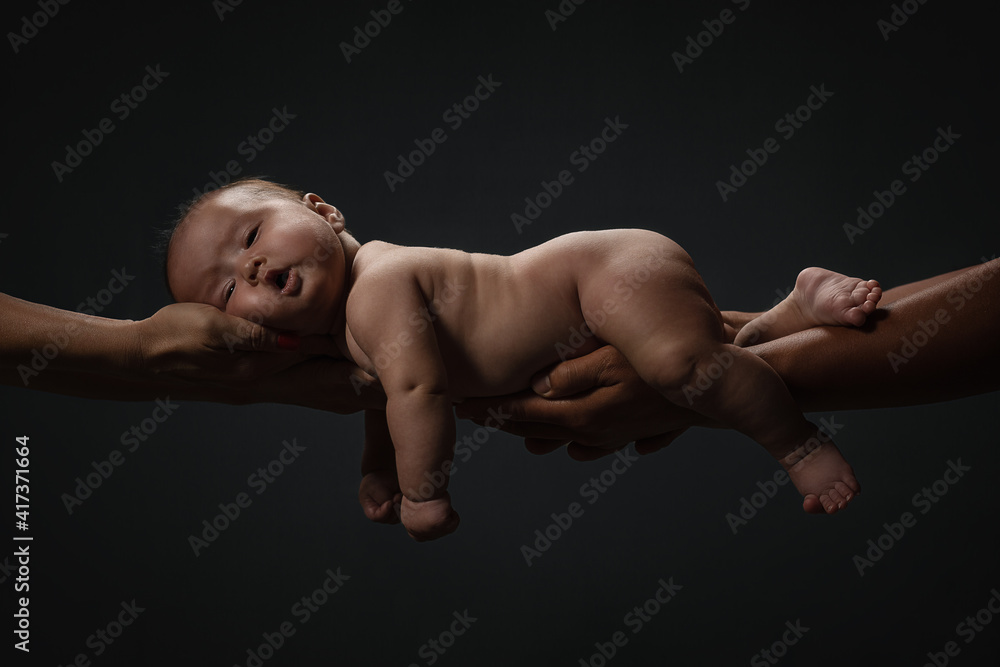 Baby Newborn Sleeping On Parents Hands over dark background, Kid And Family Concept