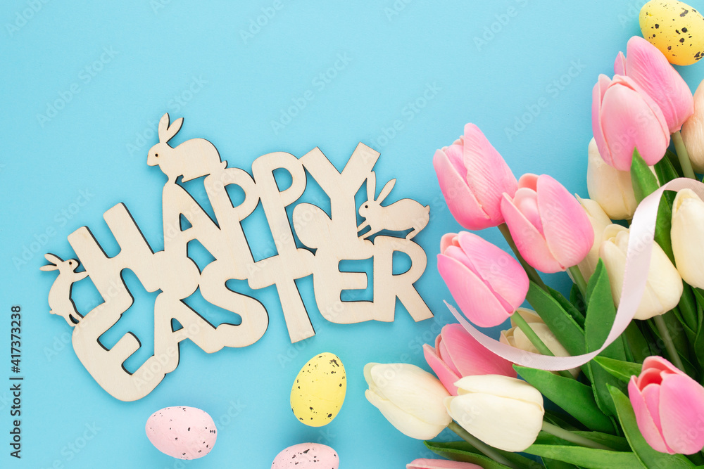 Happy Easter wooden sign with tulips on a blue background Happy Easter wooden sign with tulips on a blue background