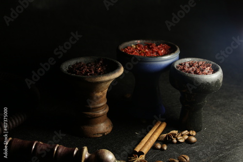 bowl with hookah tobacco. shisha with fruits on black background.