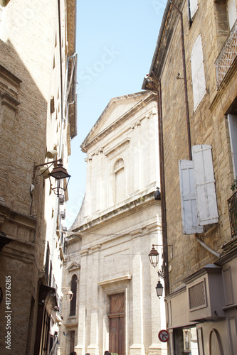 Vertical low angle shot of a neighborhood with old buildings in Pezenas, France photo