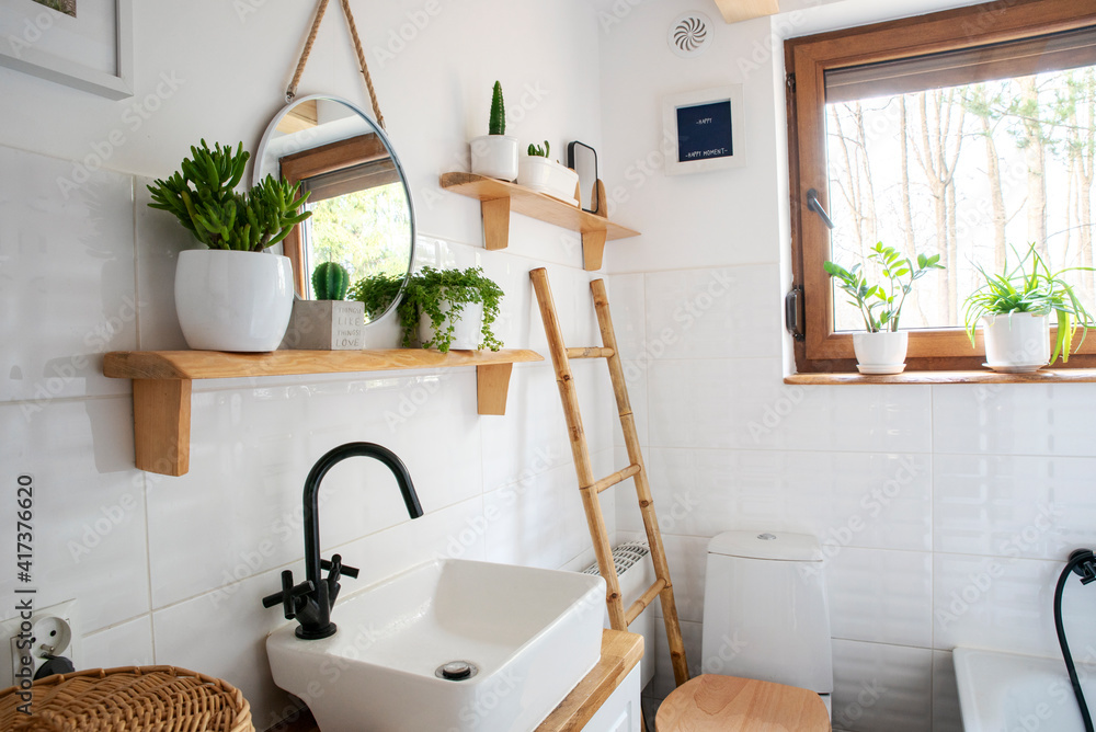 Bathroom with white tiles, window, stylish basin, round mirror, plants and  wooden shelf in rustic style. Interior of vintage cottage. Stock Photo |  Adobe Stock