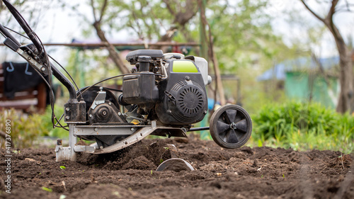 Wallpaper Mural Man farmer working in field ploughing the land with a plough on a farm. Ploughman on a walk behind motor cultivator. Season processing soil in village. Organic cultivate natural products. Agriculture  Torontodigital.ca
