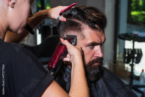 Professional care for face. male trendy hairdo. perfect haircut with blade razor. barber master cut hair. mature hipster with beard at hairdresser. brutal hipster with moustache making new hairstyle