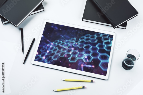Creative abstract wireless technology hologram with hexagon on modern digital tablet display, artificial intelligence and machine learning concept. Top view. 3D Rendering