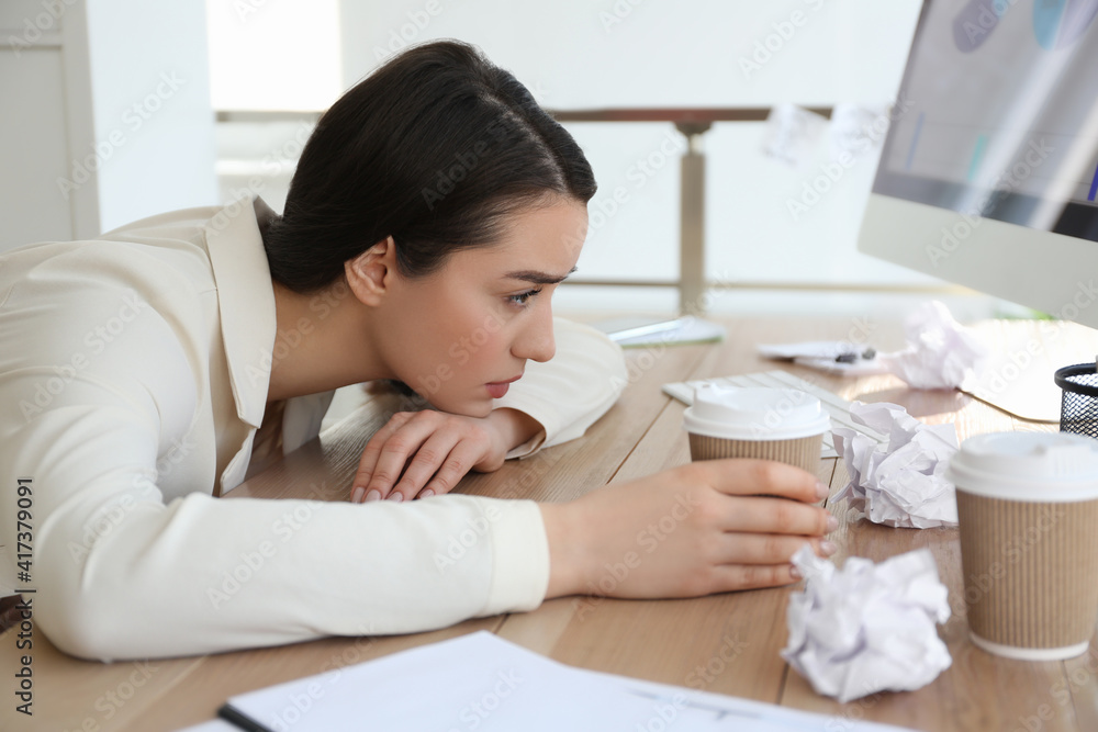 Businesswoman stressing out at workplace in office Businesswoman stressing out at workplace in office