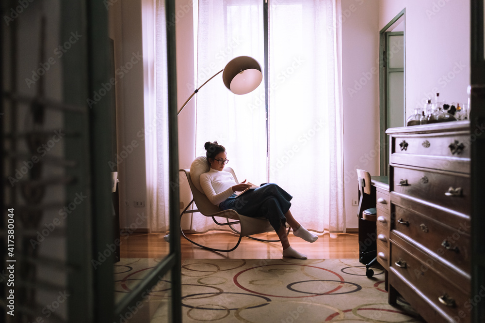 Young woman reading a book at home Young woman reading a book at home