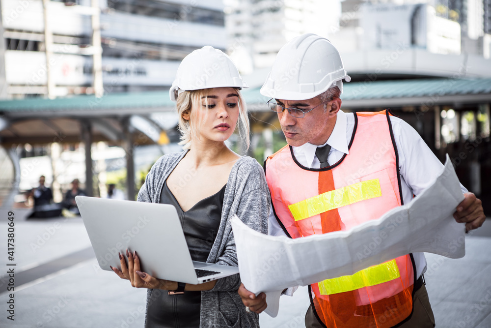 Two engineers are planning at work site. Two engineers are planning at work site.